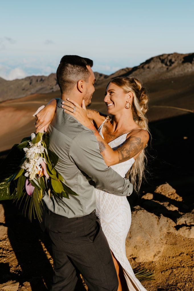 A bride admires her groom with her hand placed on his face at their elopement in Haleakala National Park