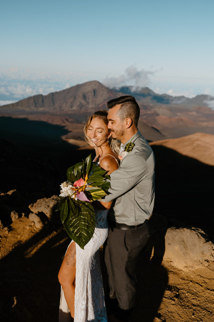 A man embraces his wife after they've eloped in Haleakala National Park