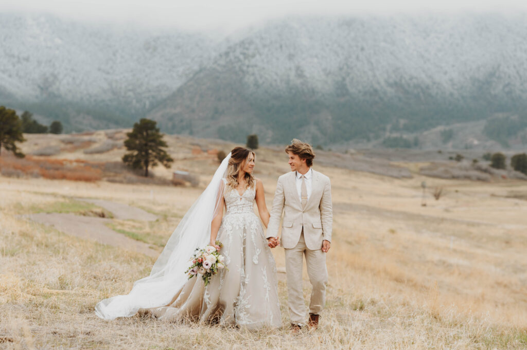 Newlyweds in Colorado walk hand in hand after eloping.