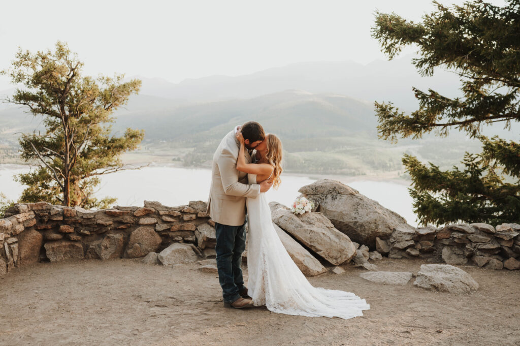 A couple kisses while overlooking Dillon Reservoir.