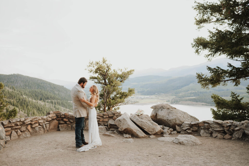 A bride and groom embrace atop Sapphire Point Overlook.