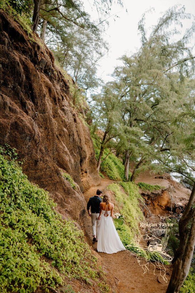 A couple walks along a hiking path in Maui after their elopement