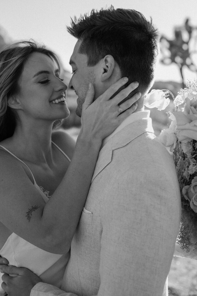 A woman kisses her husband during their adventure elopement in Joshua Tre