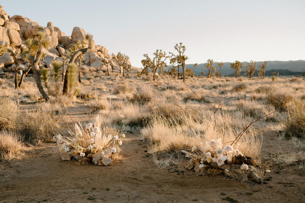 Large wedding florals are seen in a desert landscape near Joshua Trees