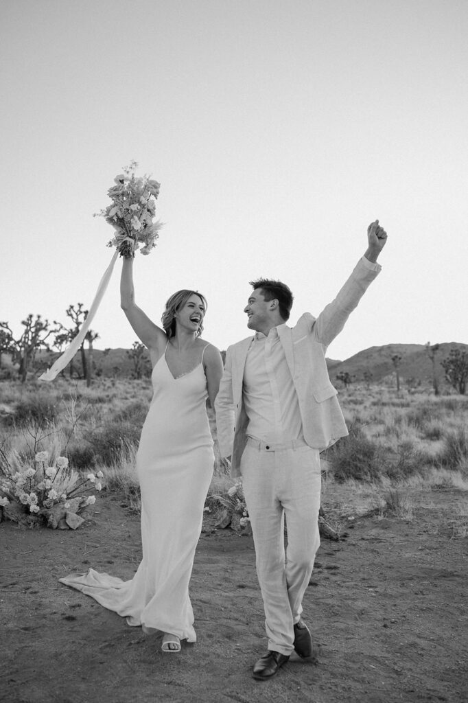 Newlyweds cheers in celebration over their Joshua Tree elopement day