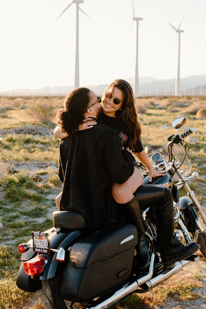 A couple embraces on a motorcycle during a romantic Palm Springs couple getaway