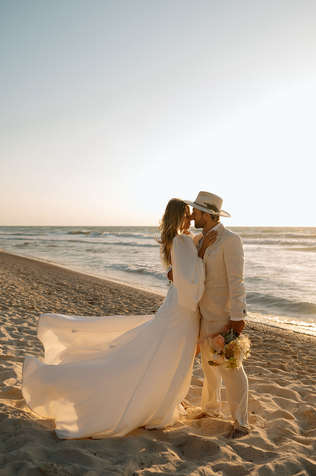 A newly married couple stands on a beach near the Caribbean Sea at Casa Violeta