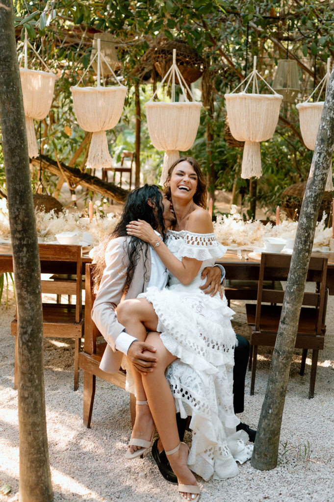 A couple laughs during their Tulum wedding reception 