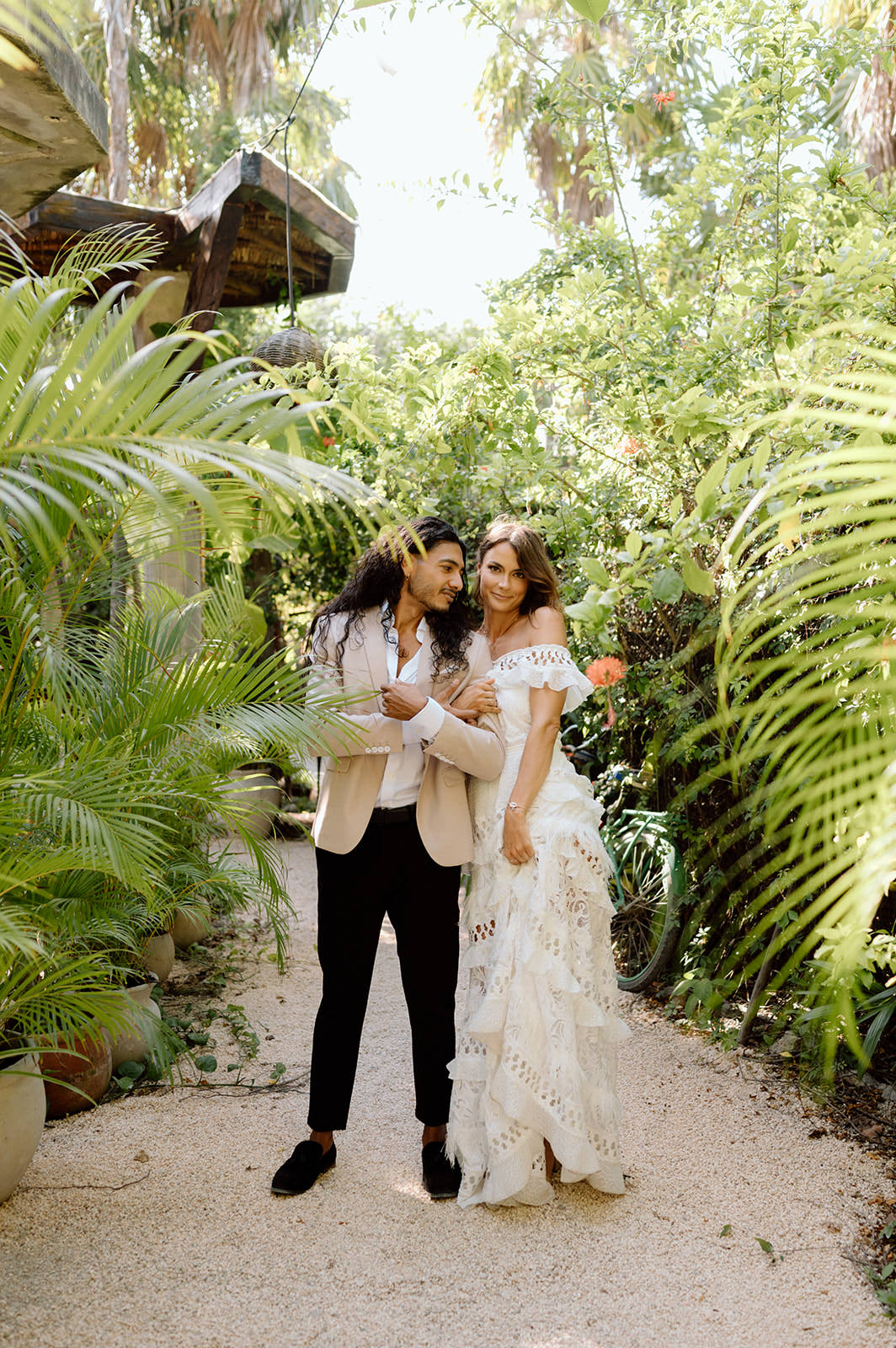 A couple poses in a jungle in Tulum for their adventure elopement