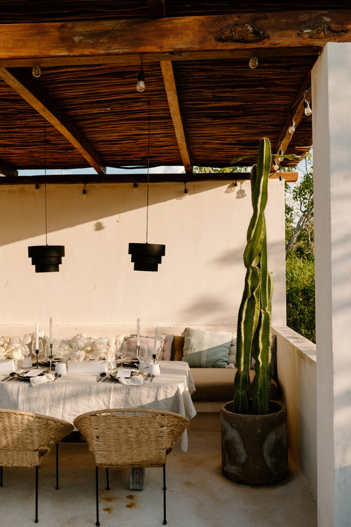 A neutral tablscape at a Tulum wedding reception is seen at Sunset