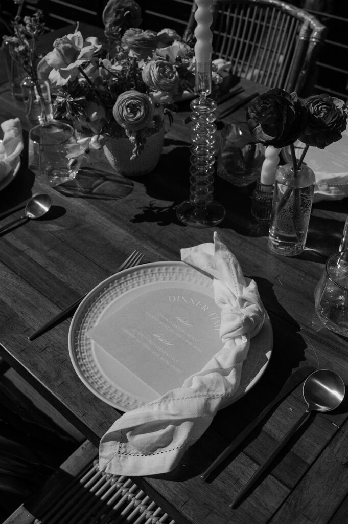 A tablescape is seen in black and white for a mountain elopement.