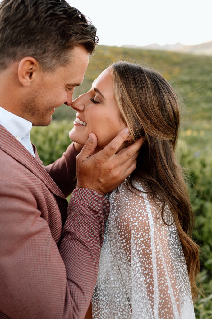 Newlyweds touch each other's nose during their wedding portraits.