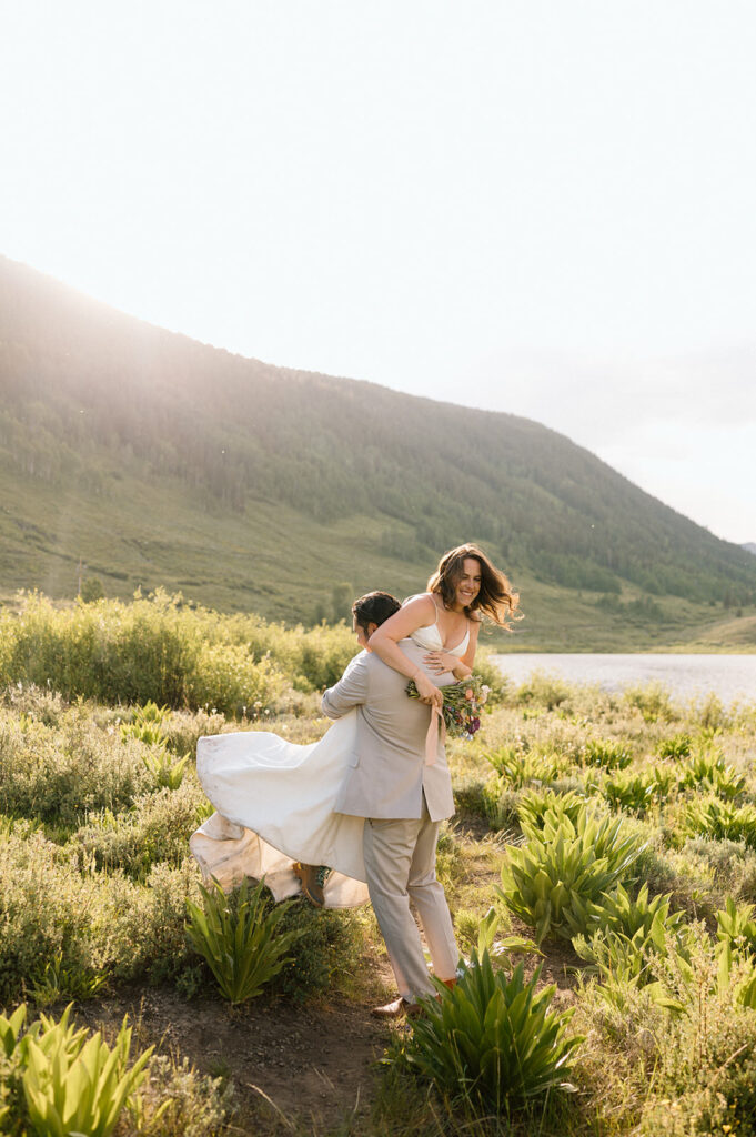 Newlyweds twirl during their outdoor Colorado elopement.