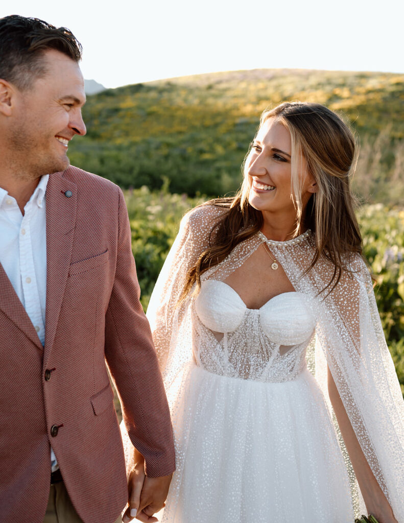 A recently married couple shares smiles at one another during a Crested Butte hike.