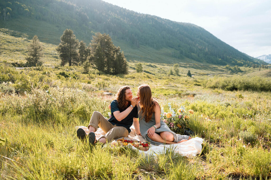 A couple enjoys a picnic together in a Colorado alpine meadow in Summer.