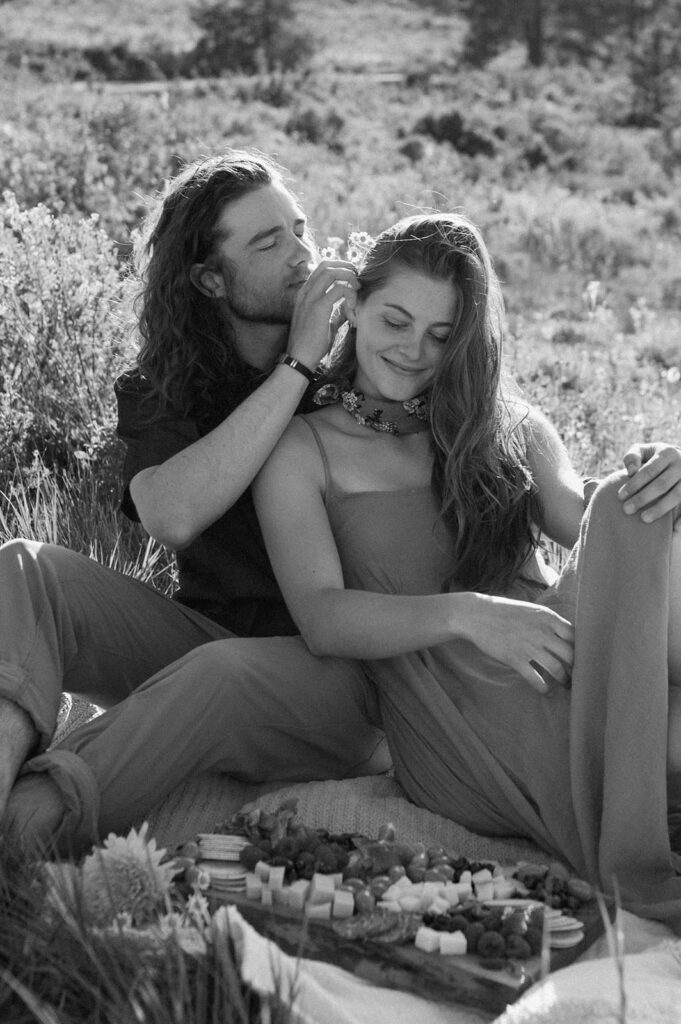 A man places a flower gently in a woman's hair in Colorado.