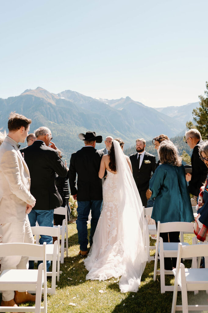 A father walks his daughter down the aisle during an Ouray intimate weddinig.