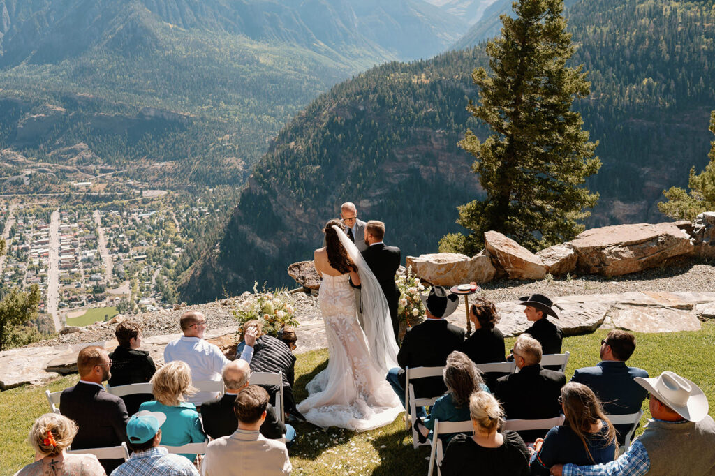 A couple says their vows during their Ouray wedding while overlooking the small moutain town. 