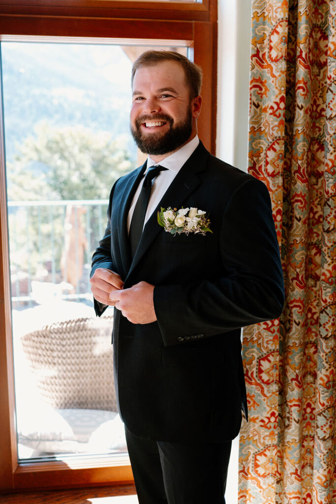 A man gets ready for his wedding at Golden Mountain Ranch.