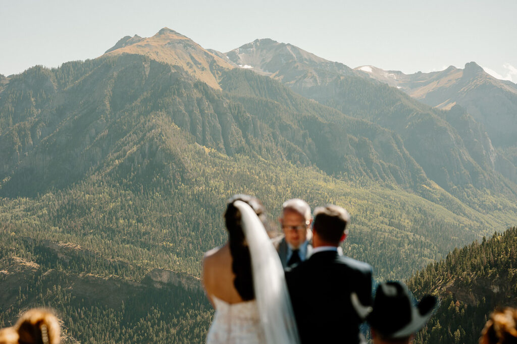 A couple stands for their wedding ceremony that overlooks Ouray, Colorado. 