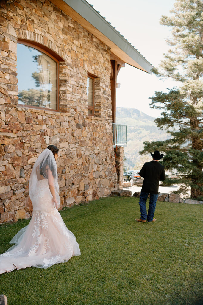 A woman shares a first look with her father, who is wearing a cowboy hat. 