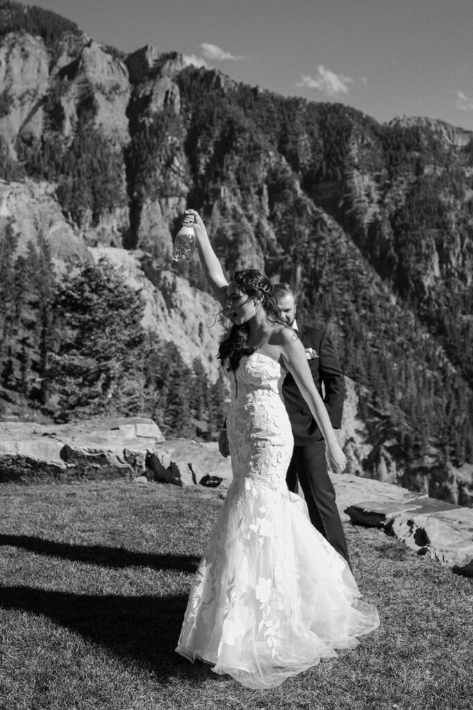 A couple celebrates with champagne during their Ouray elopement. 