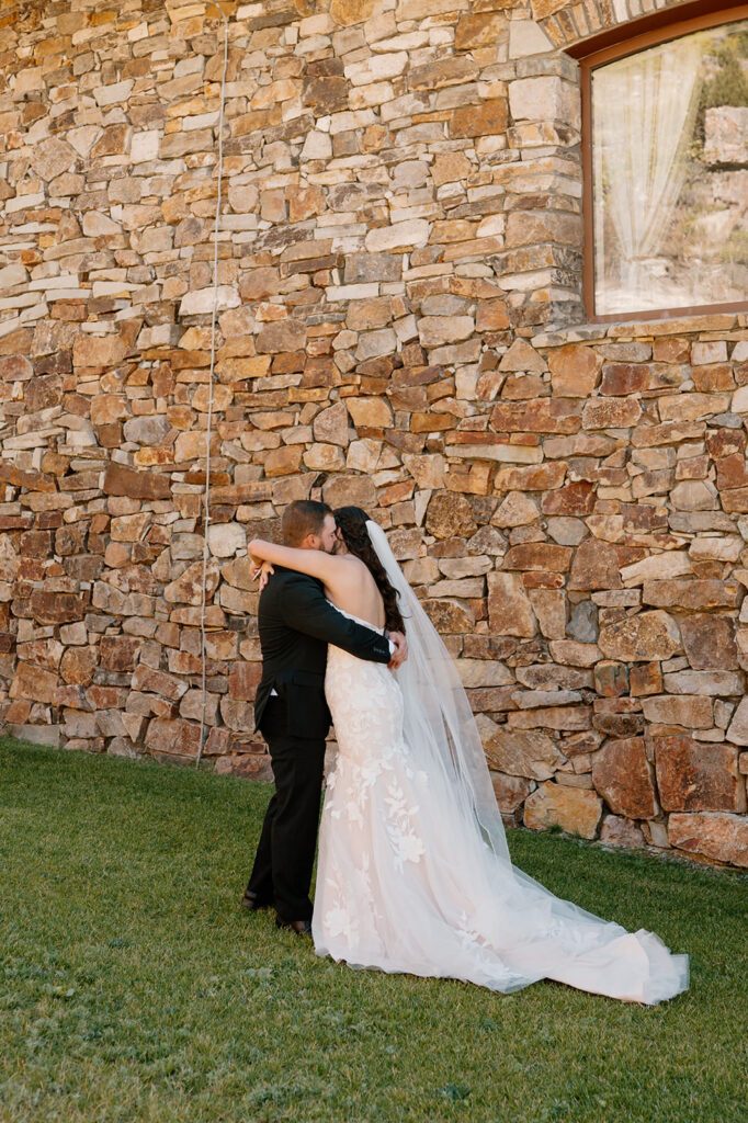 A couple embraces while standing by a mountain lodge in Ouray, Colorado. 