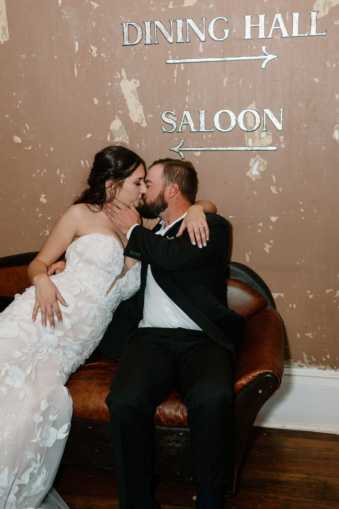 A couple kisses in a remodeled wild west hotel in Colorado. 