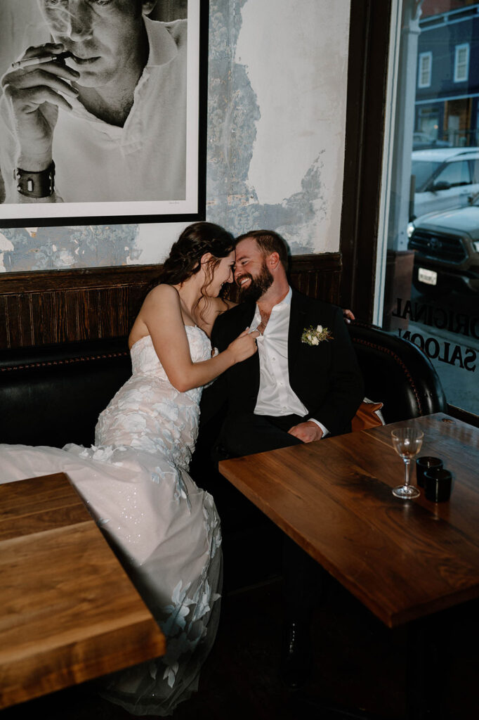 A couple embraces in a booth in a saloon in Ouray. 