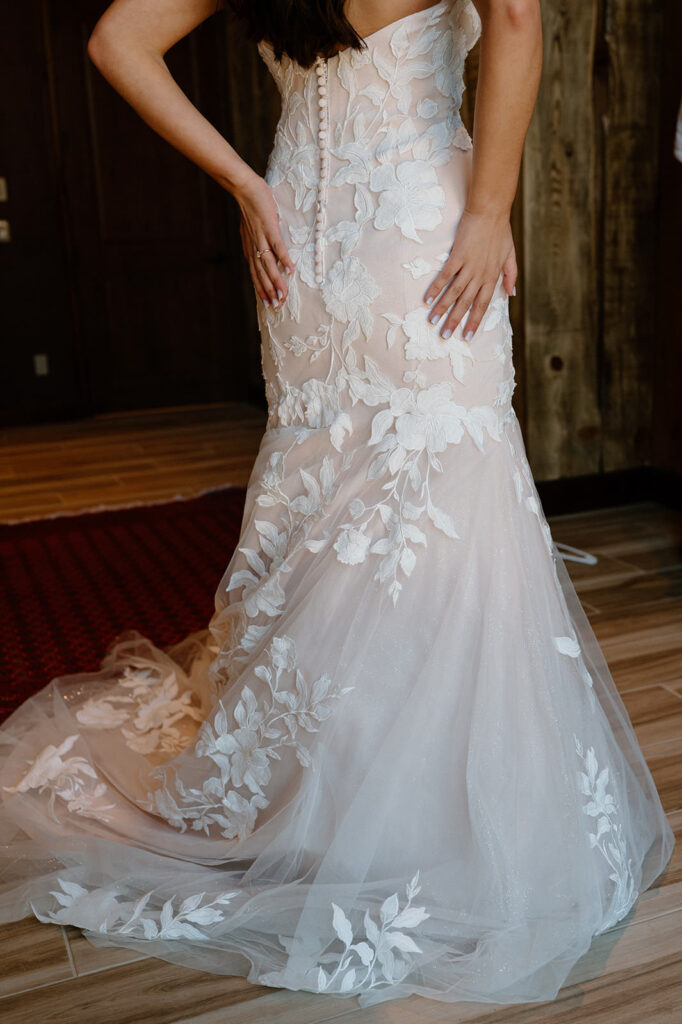 A long white wedding dress with floral lacework. 