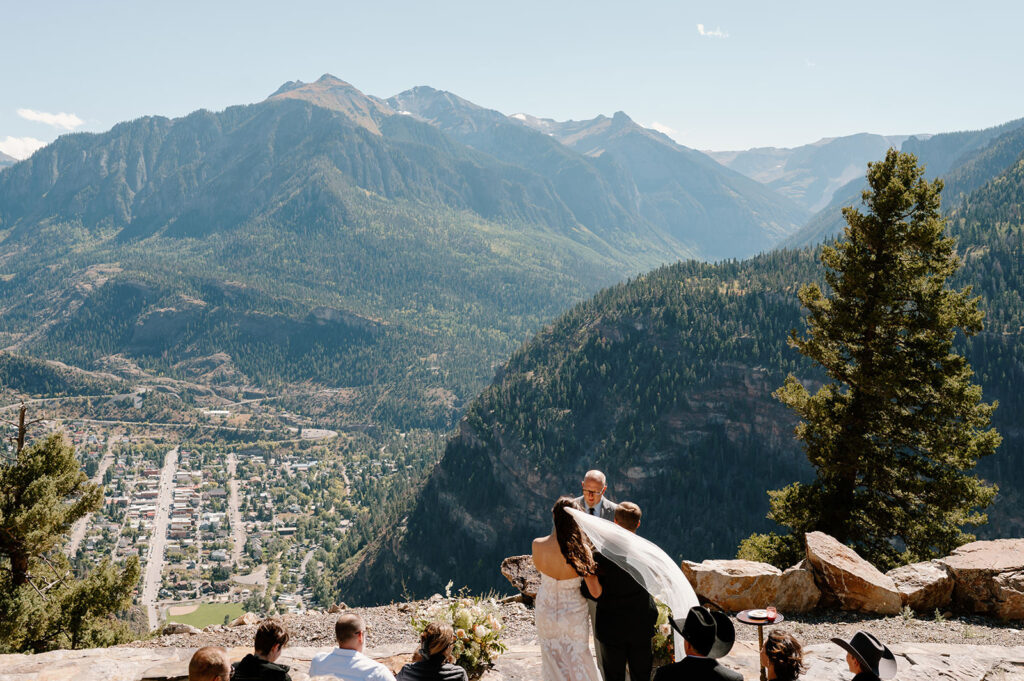 A couple stands in front of an officiant during their Ouray Colorado elopement.