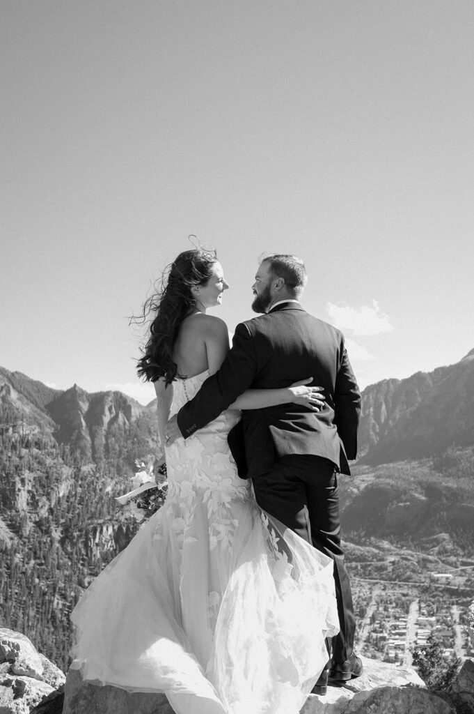 A couple overlooks onto the town of Ouray during their intimate wedding. 
