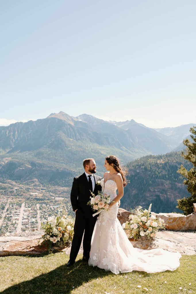 A couple takes wedding portraits on a mountain in Ouray. 
