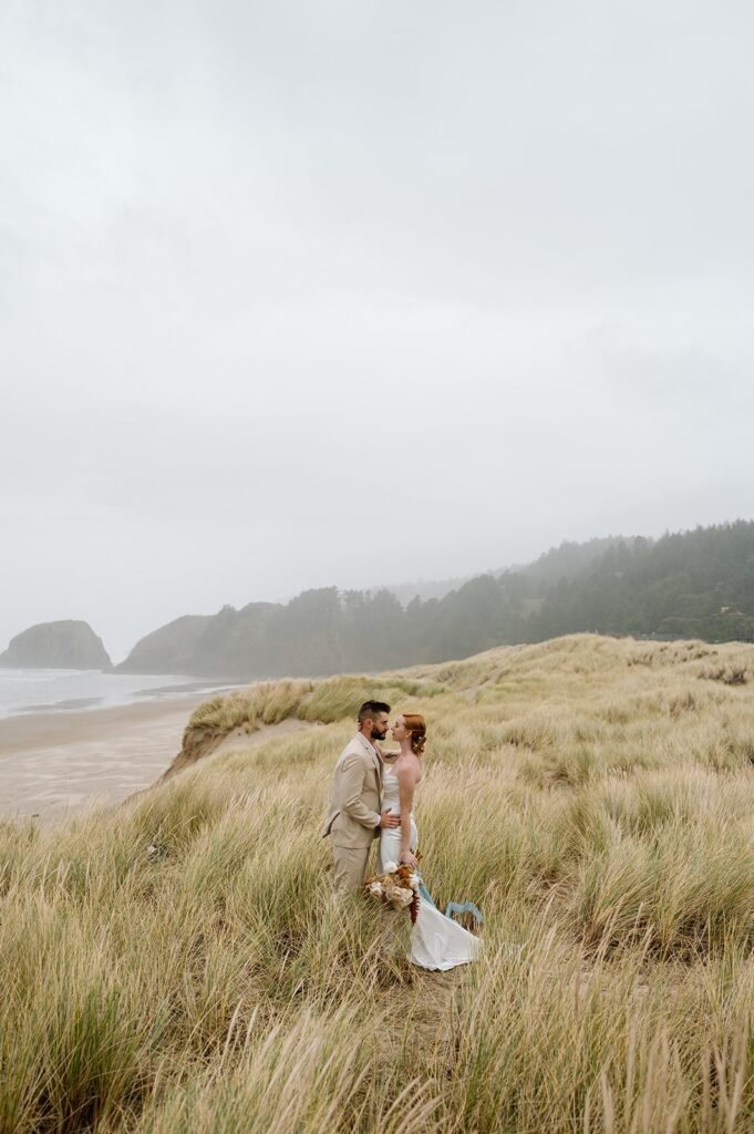 A couple faces one another during their Cannon Beach elopement. 