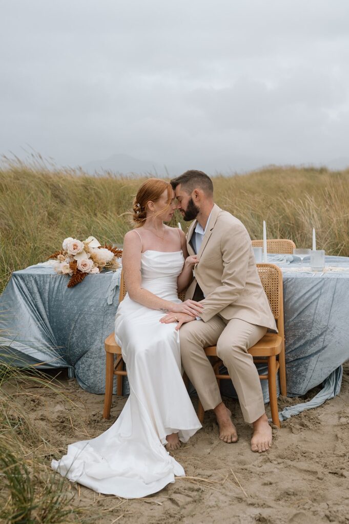 A couple goes in for a kiss during their intimate wedding at an Oregon Beach. 