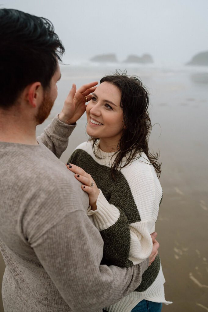A couple admires one another during their Cannon Beach engagement session. 