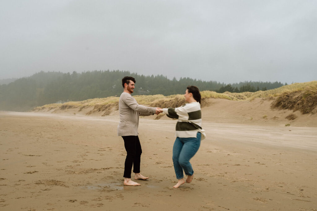 A couple twirls on a rainy day in Cannon Beach. 