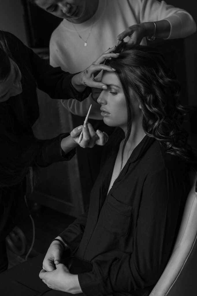 A bride gets her hair and makeup done before her Banff elopement by Makeup Asipenko.