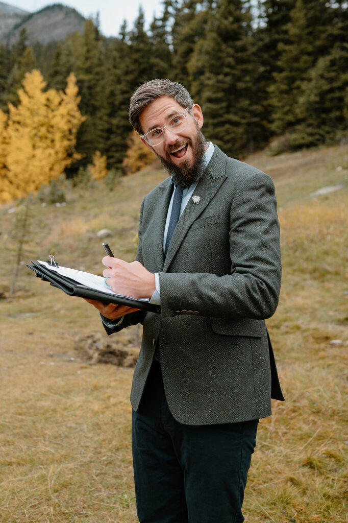 Cole from Married By Cole signing a marriage license during an intimate Banff elopement. 