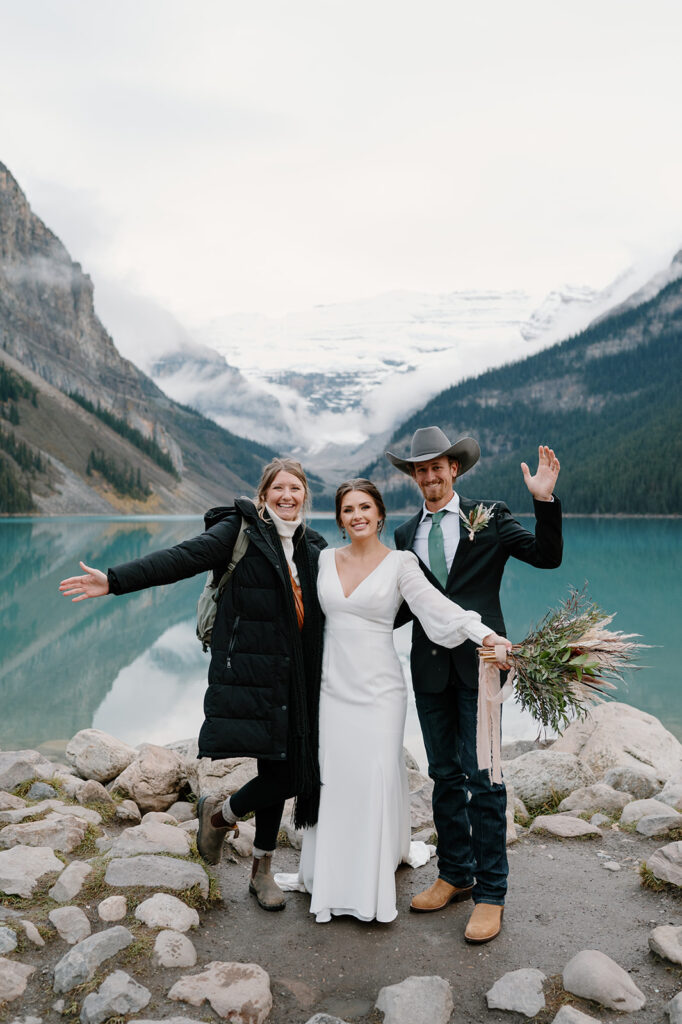 Reagan from Reagan Taylor Photography poses with a Banff elopement couple.