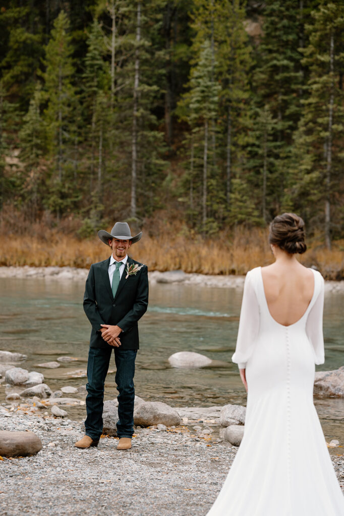 A bride and groom share a first look during their Banff elopement. 