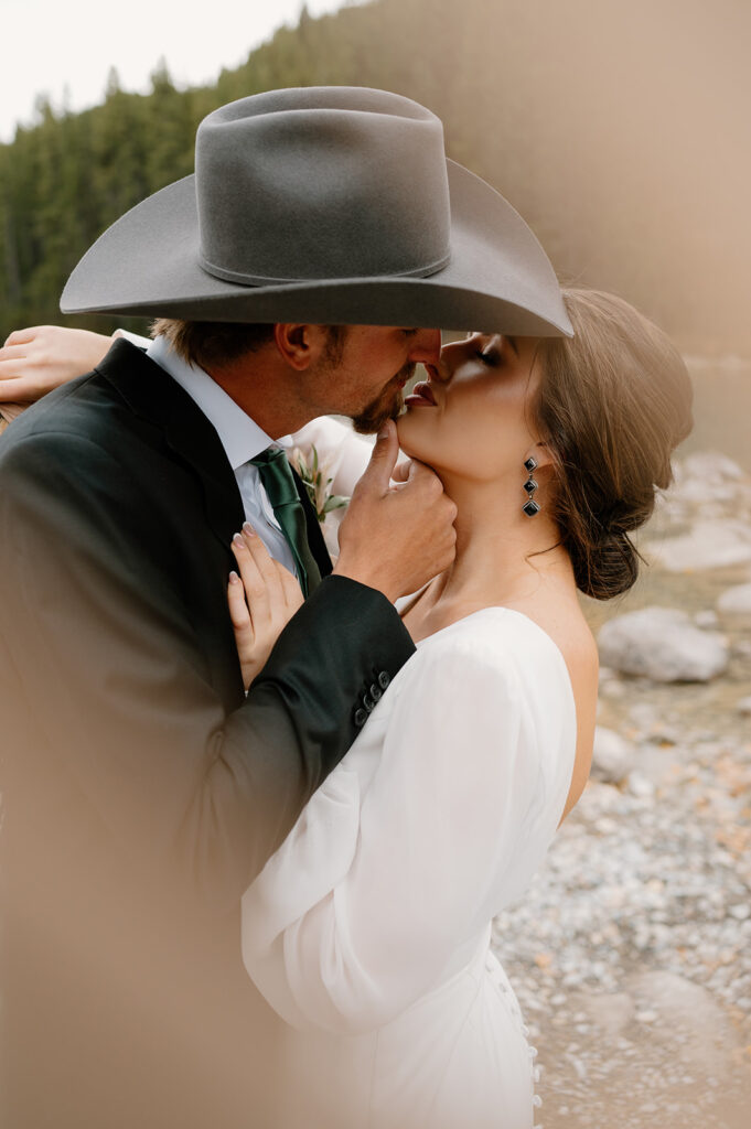 A couple goes in for a kiss during their Banff elopement. 