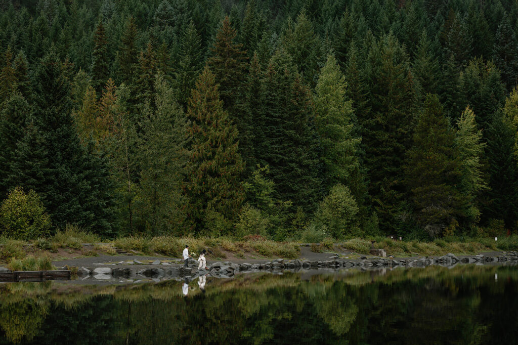 A couple is seen exploring the shores of Trillium Lake.