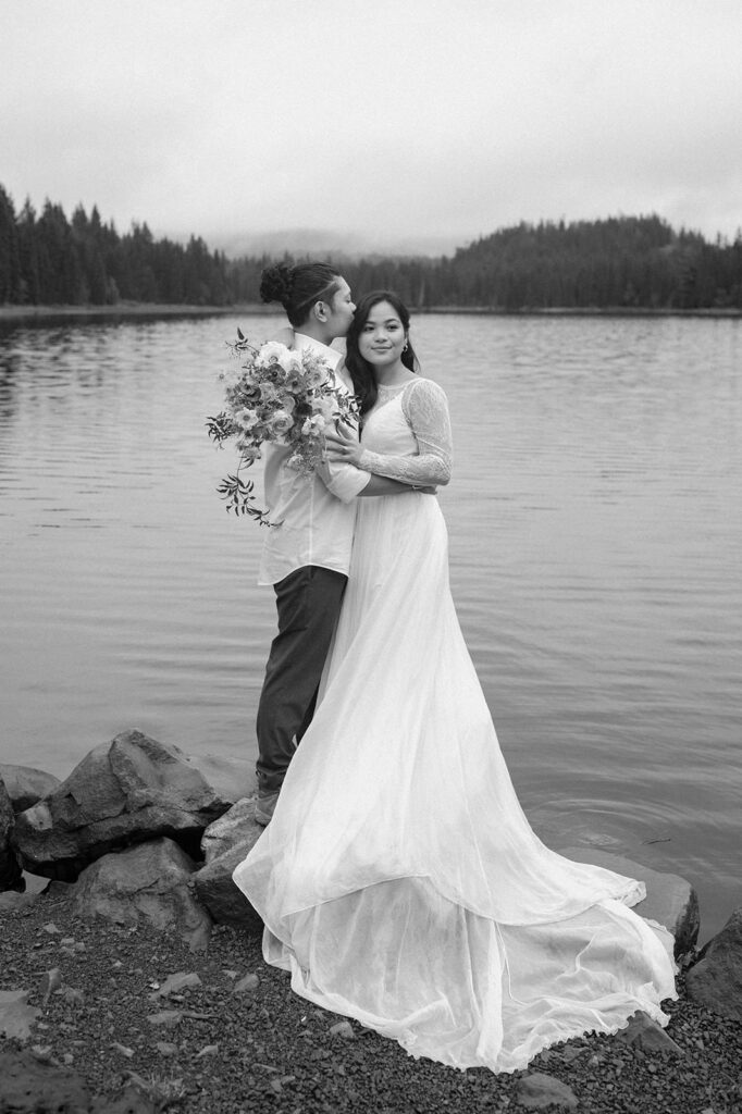 A couple poses for wedding portraits at Trillium Lake.