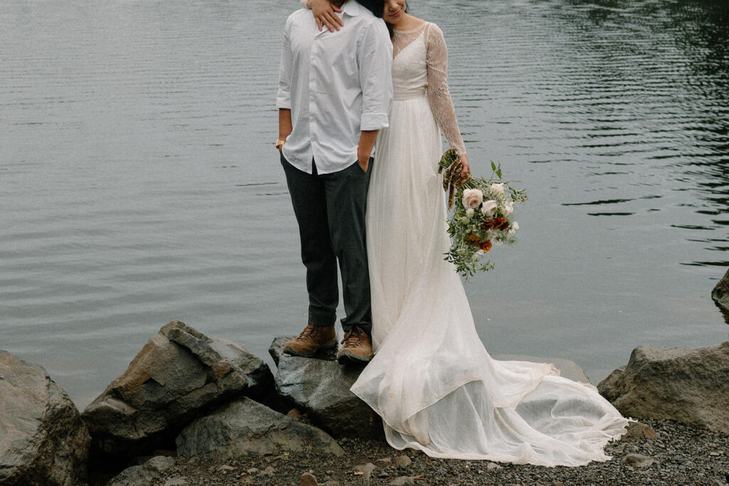 A portrait of elopement attire near by a lake.