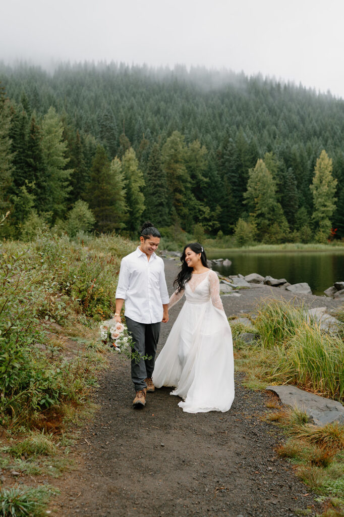 A newlywed couple hikes around Trillium Lake.