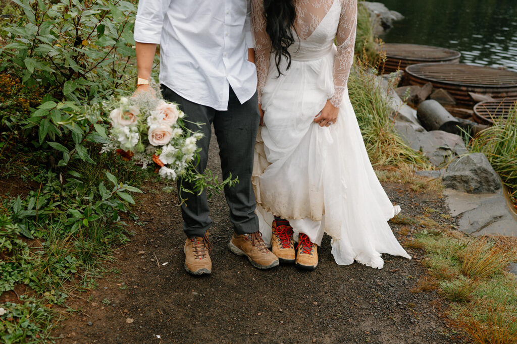 A couple eloping shoes off their hiking boots.