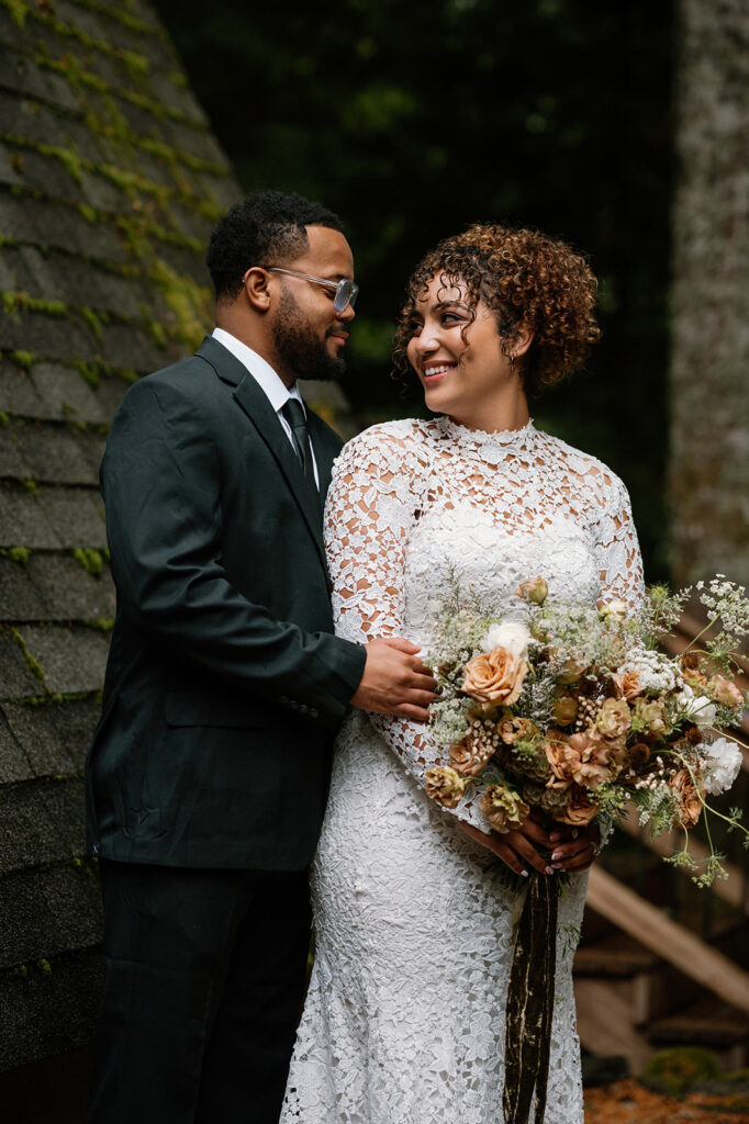 A couple stands near an A-Frame for Oregon wedding portraits. 