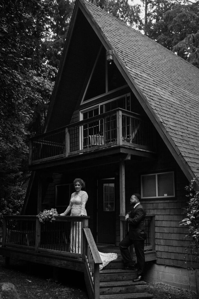 A husband and wife pose for wedding portraits at a cabin in Oregon.