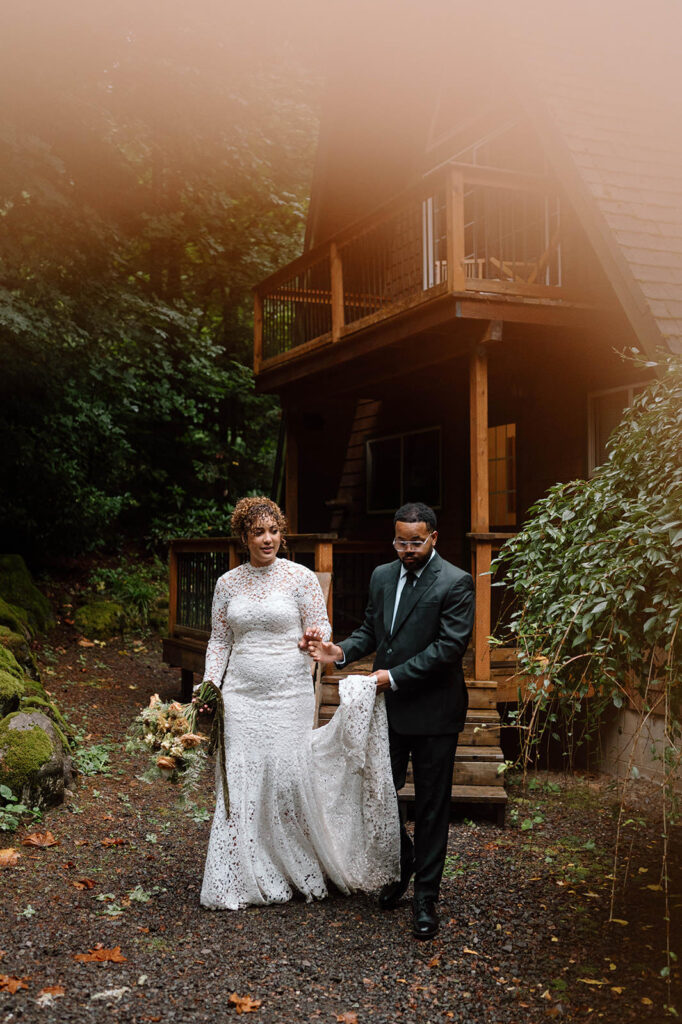 A newlywed couple walks along a gravel path in Oregon.